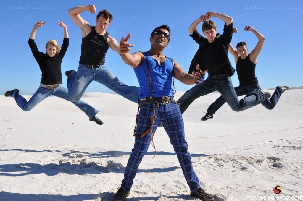 men jumping in desert