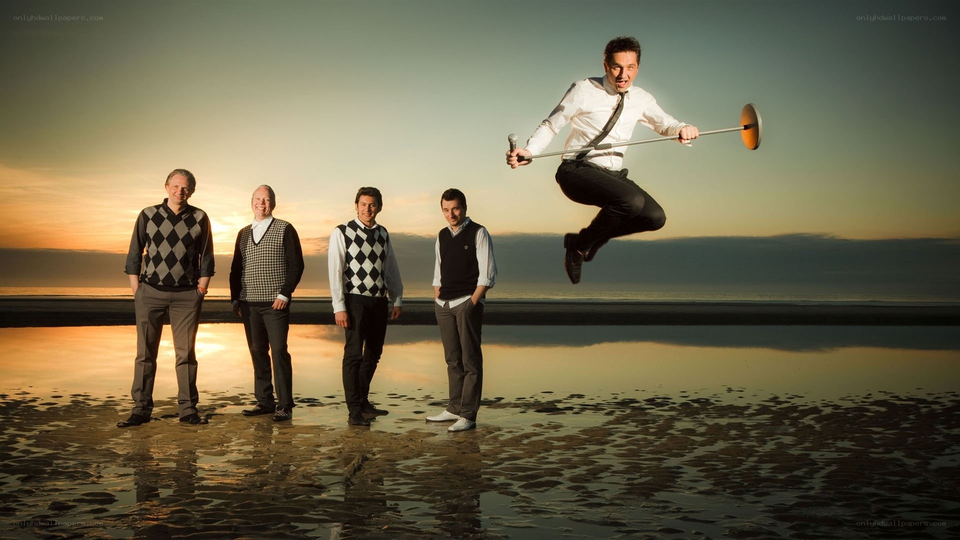 Men on a beach at sunset