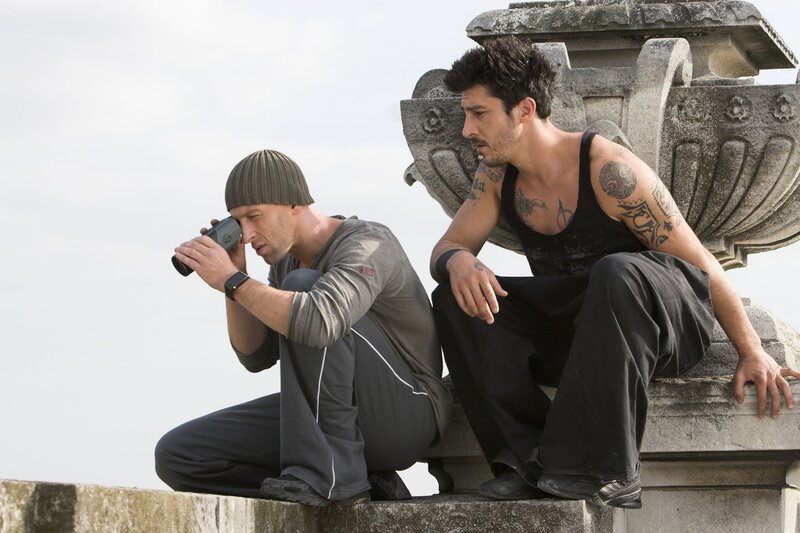 Men on a stone structure