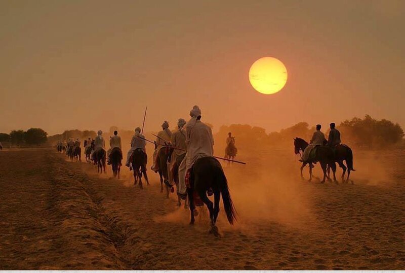Men on Horseback at Sunset