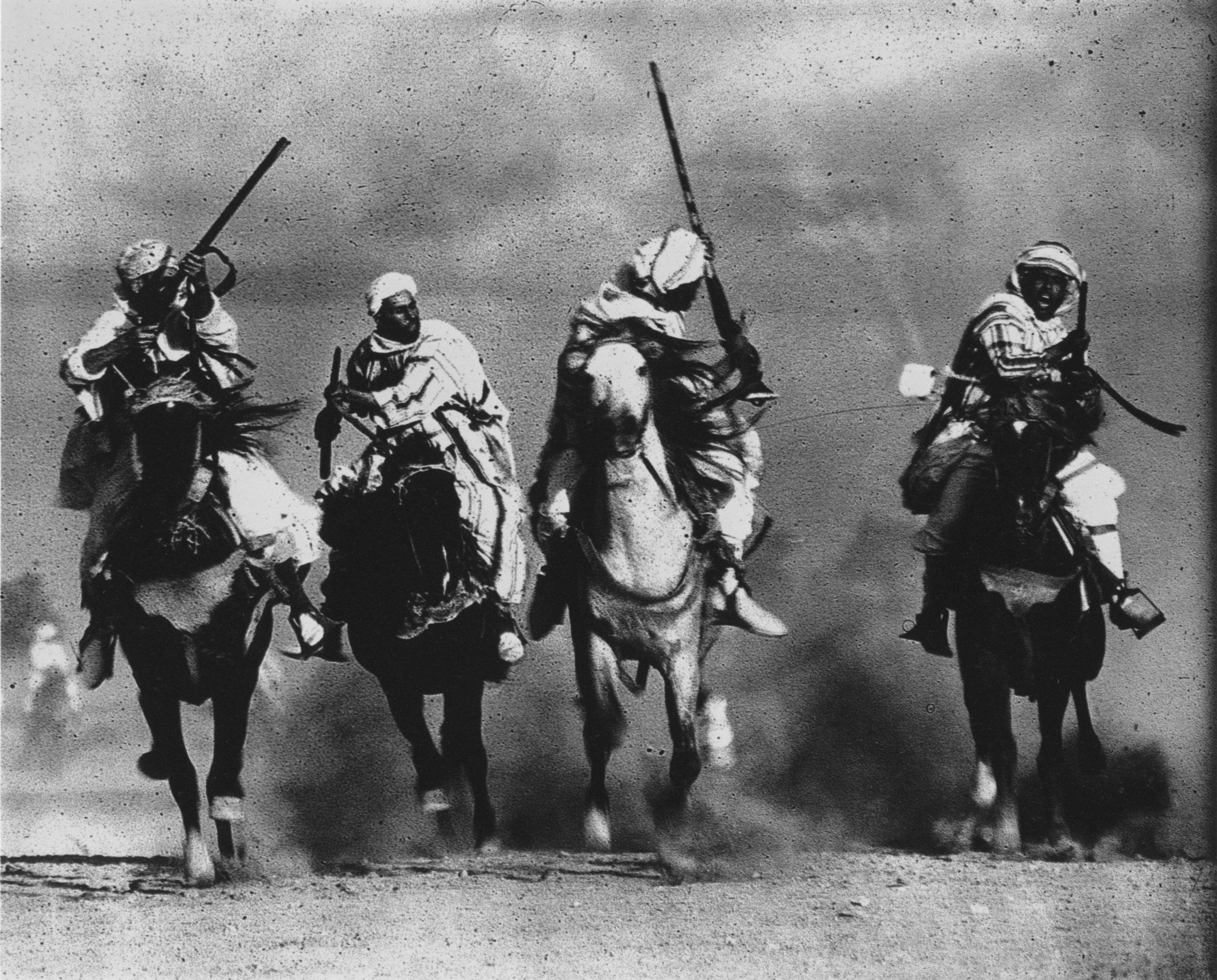 Men on horseback with rifles