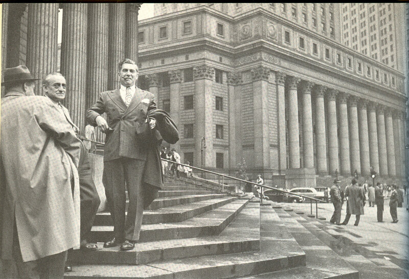 Men on steps of grand building