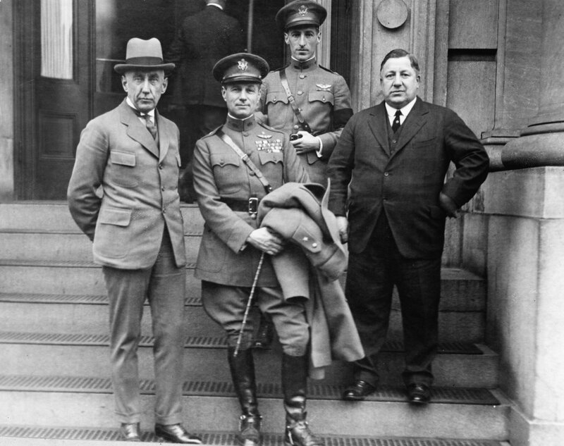 Men on steps with military officers