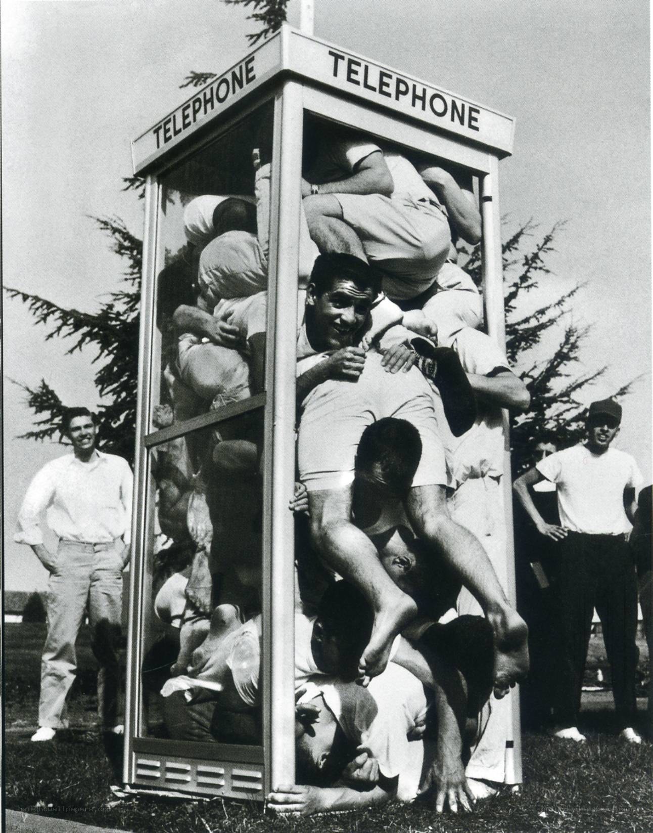 Men packed in a phone booth