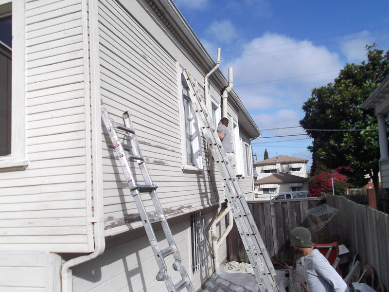 Men Painting House
