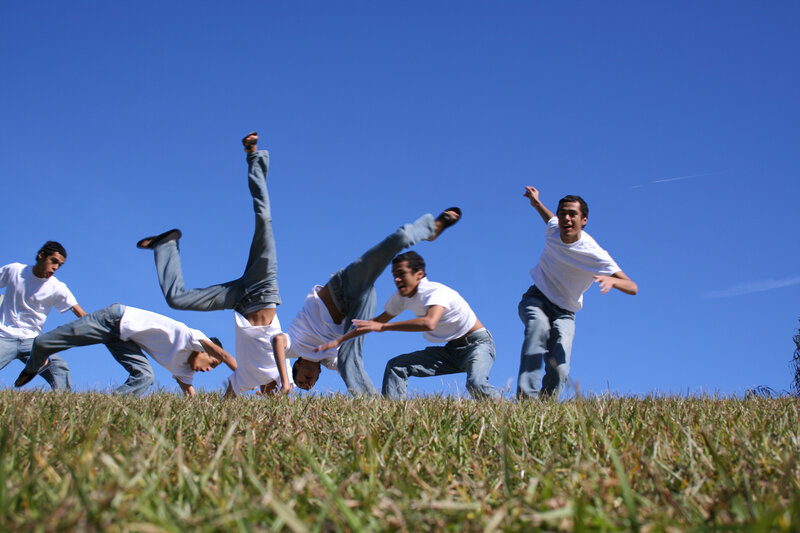 Men performing acrobatics on grass
