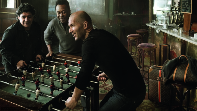 Men playing foosball in a bar