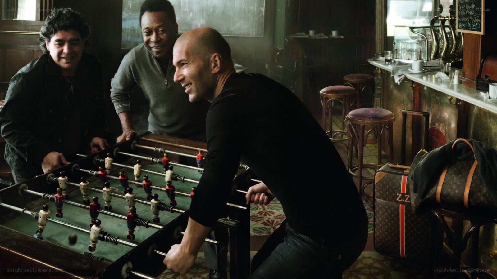 Men playing foosball in a bar