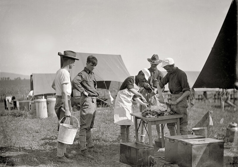 Men preparing food at camp