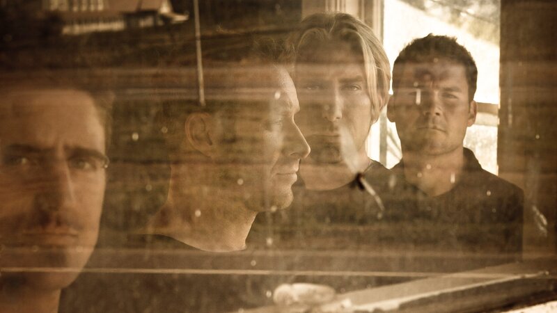 men reflected in glass