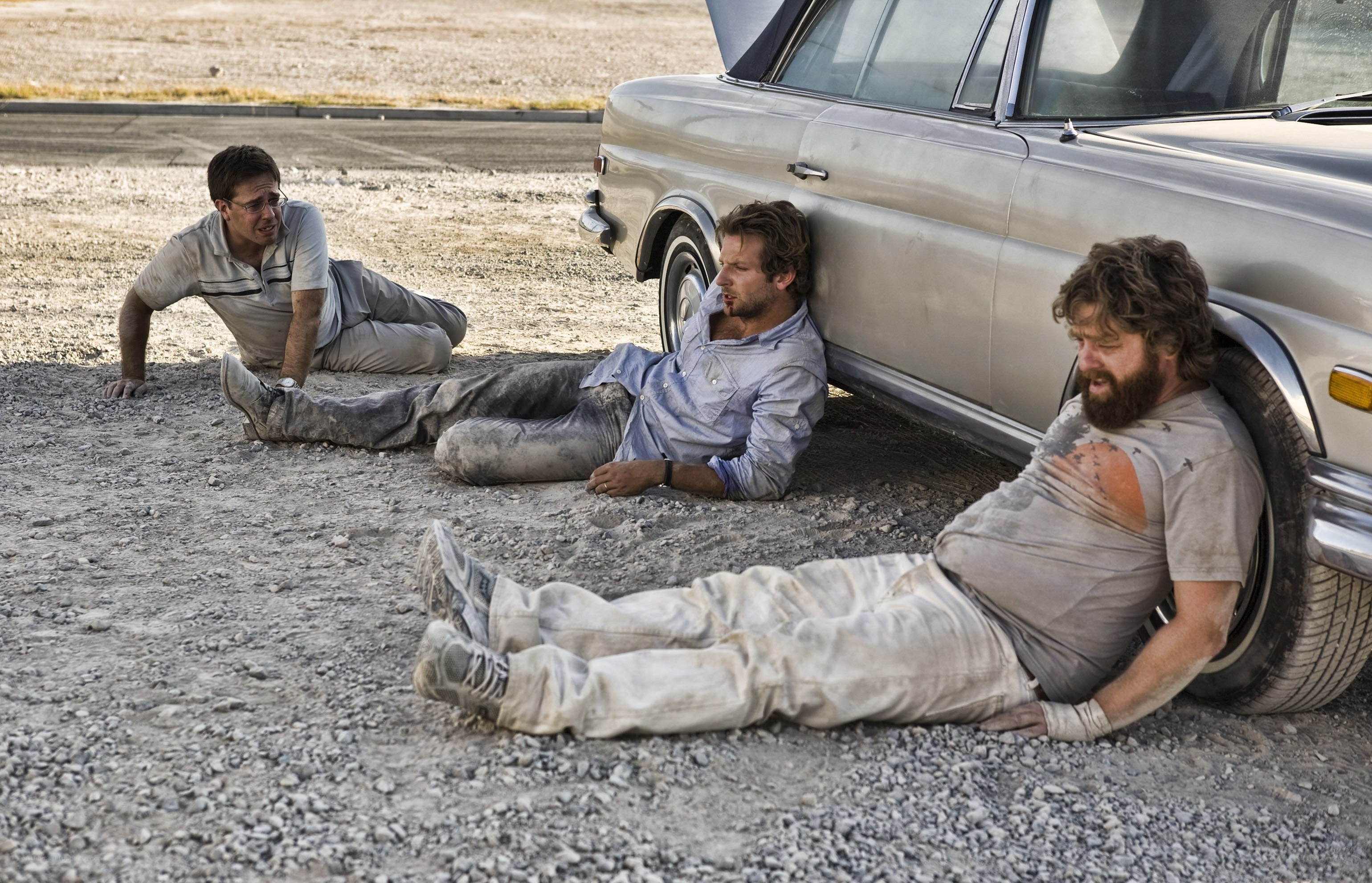 Men resting by a car