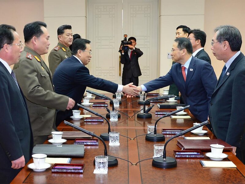 Men Shaking Hands at Table