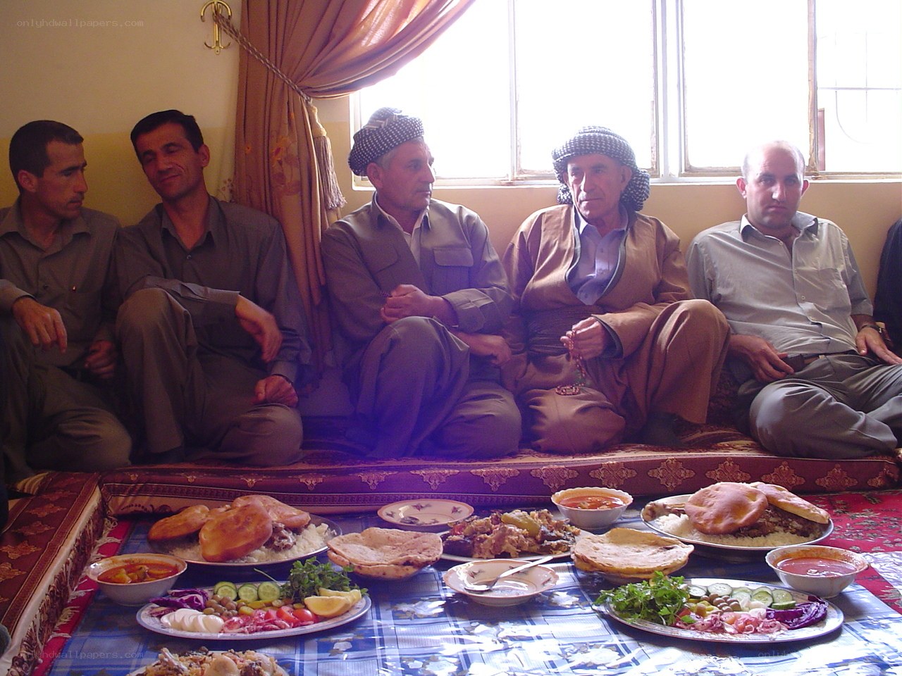 Men sharing a meal on the floor