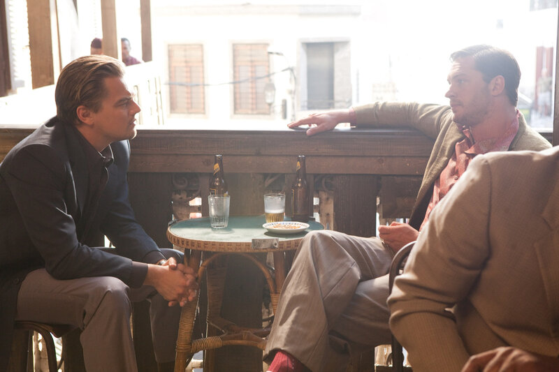 Men talking at a cafe table