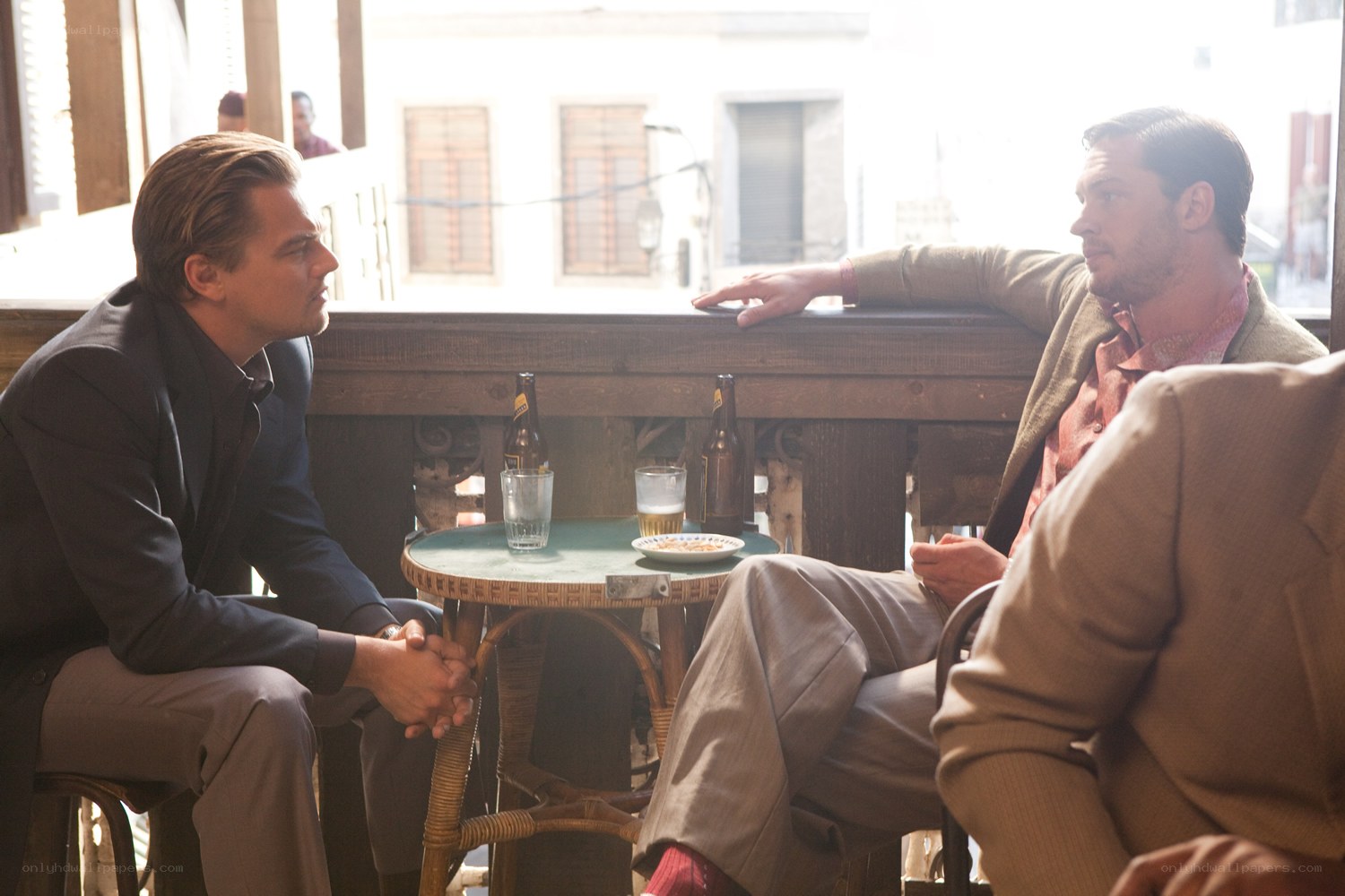 Men talking at a cafe table