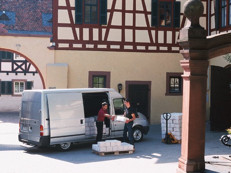 Men unloading boxes from a van