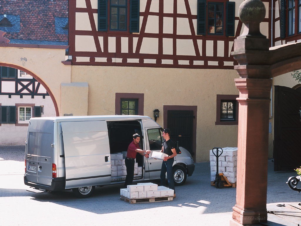Men unloading boxes from a van