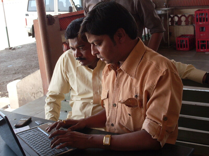 Men using laptop at counter