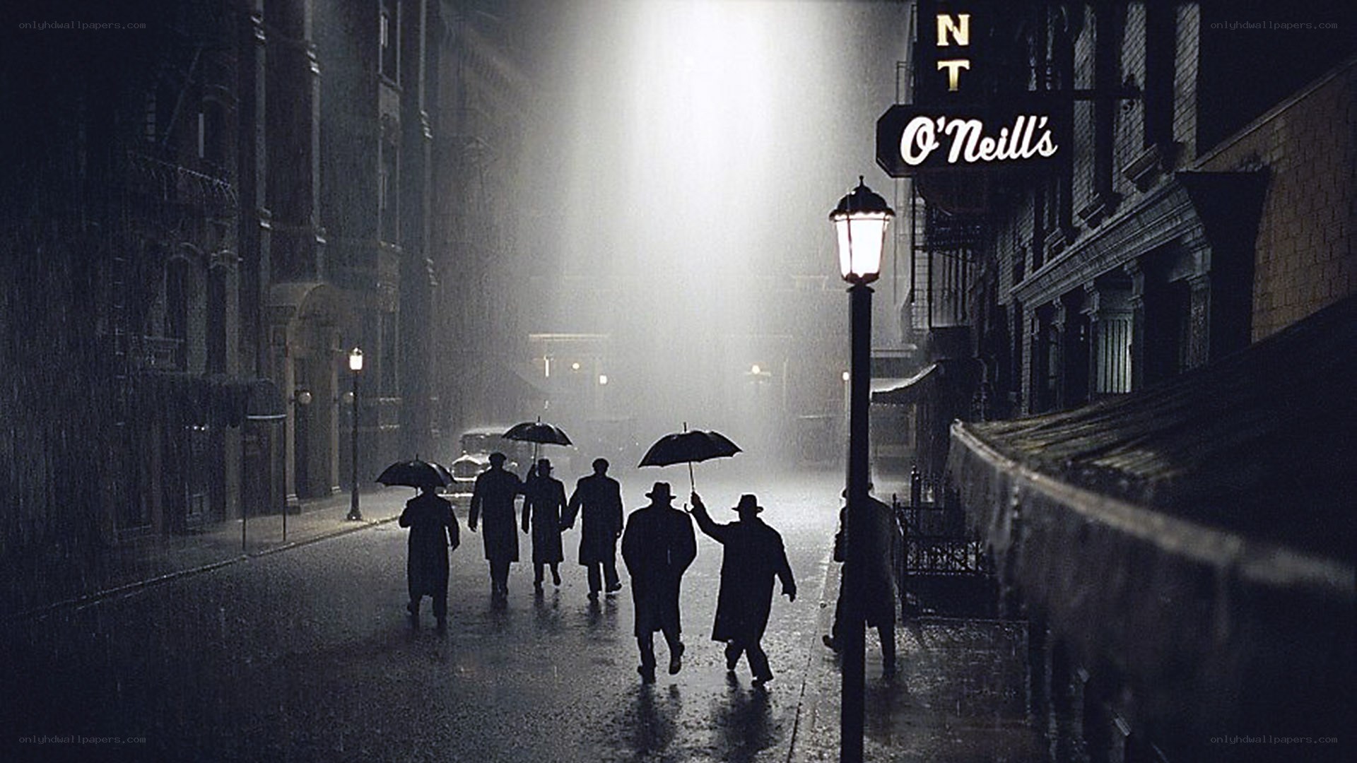 Men walking in rain with umbrellas