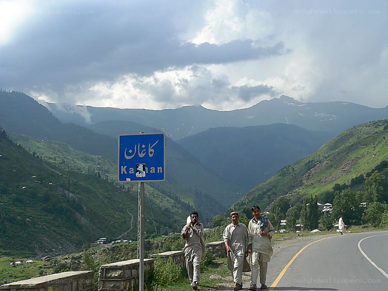 Men walking near Kaghan sign