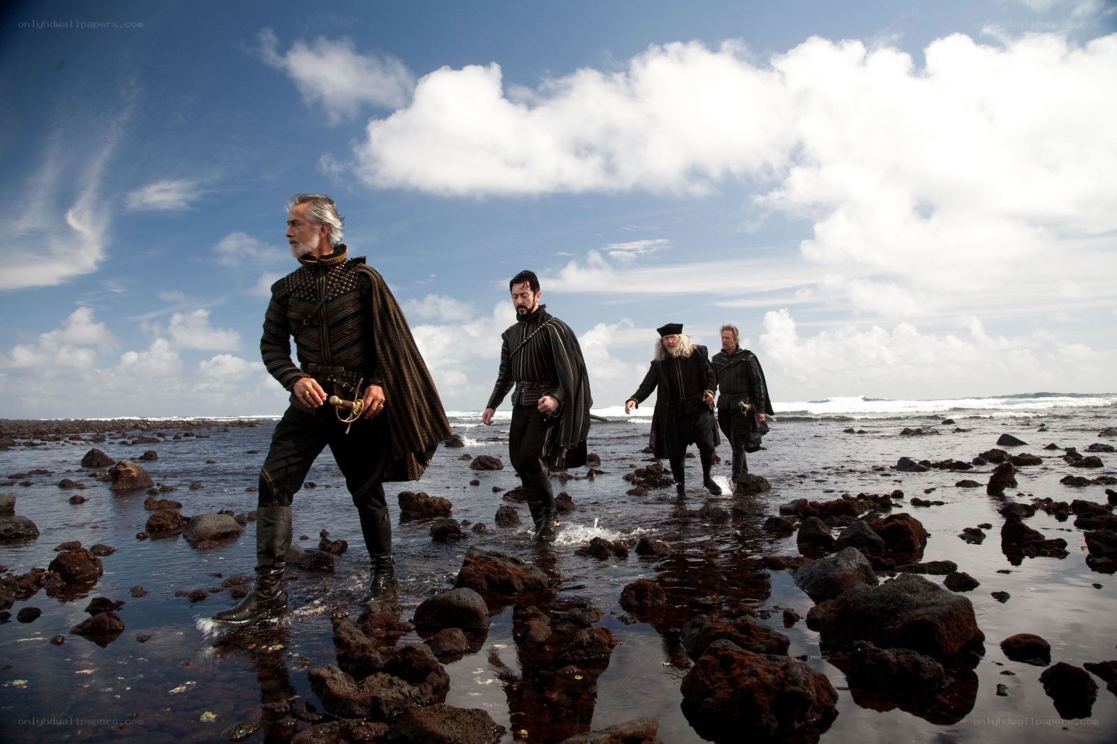 men walking on rocky beach