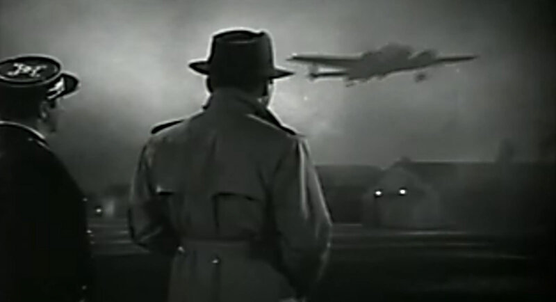 Men watch plane take off