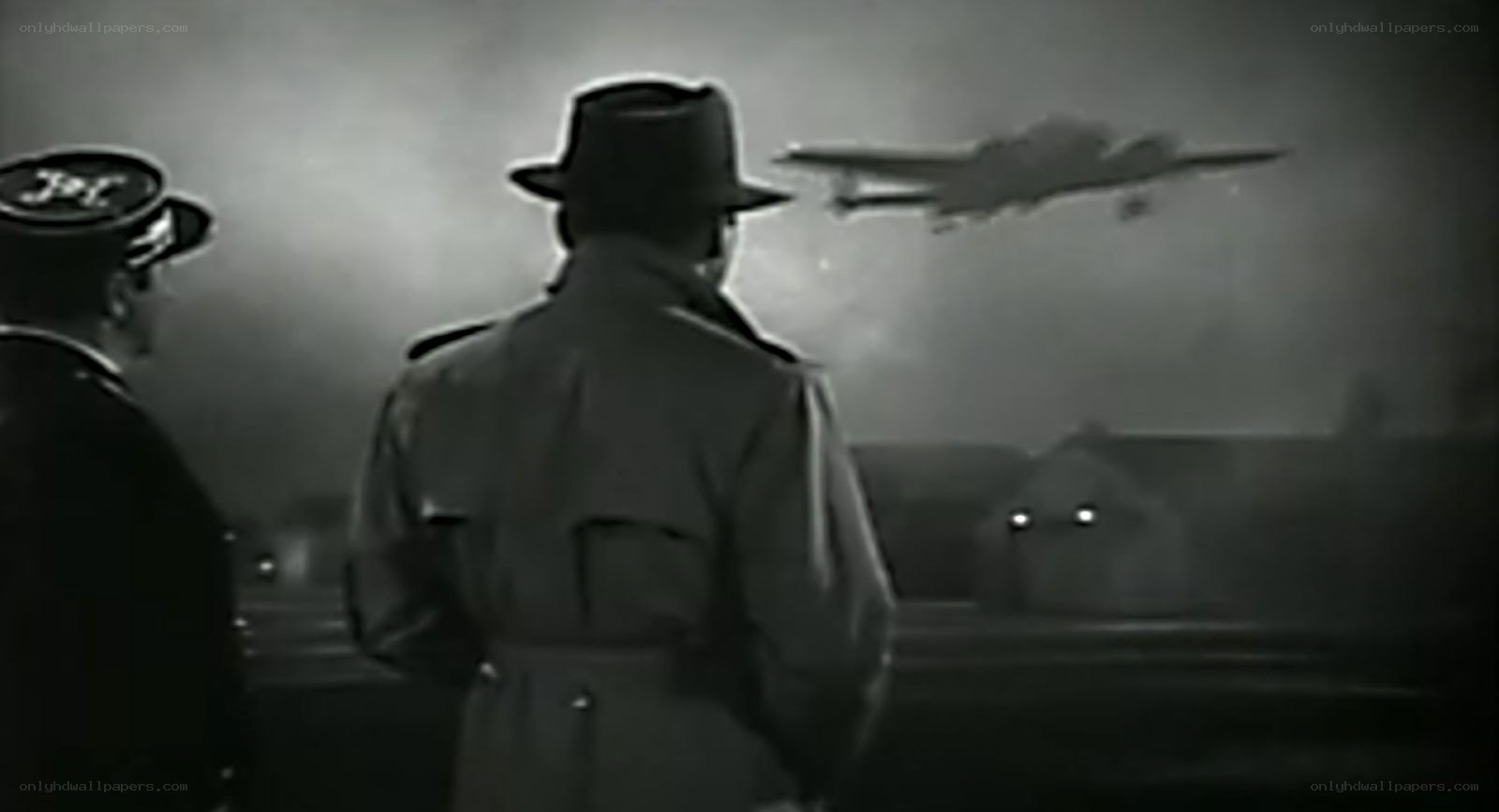 Men watch plane take off