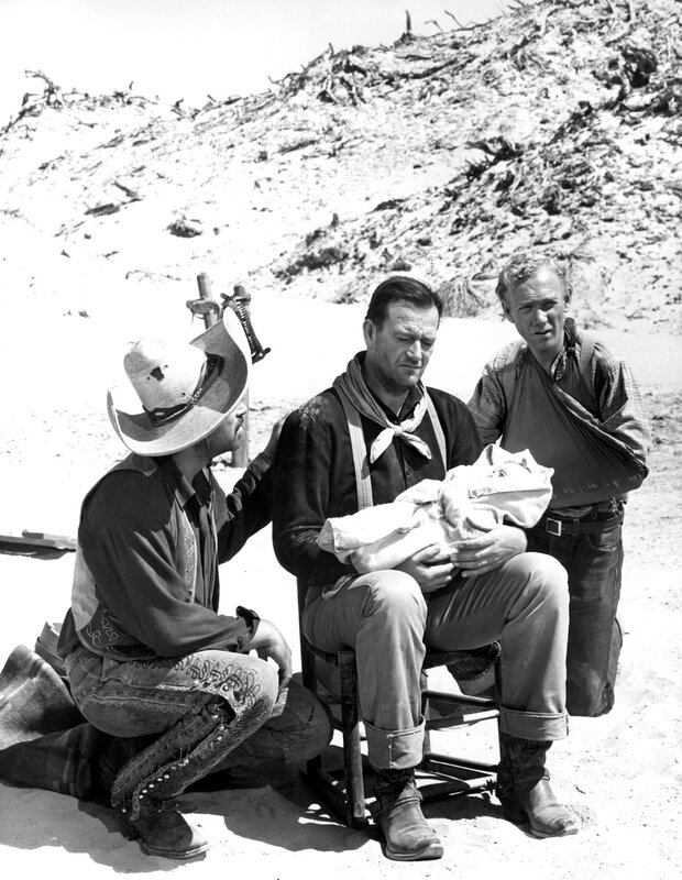 Men with baby in desert