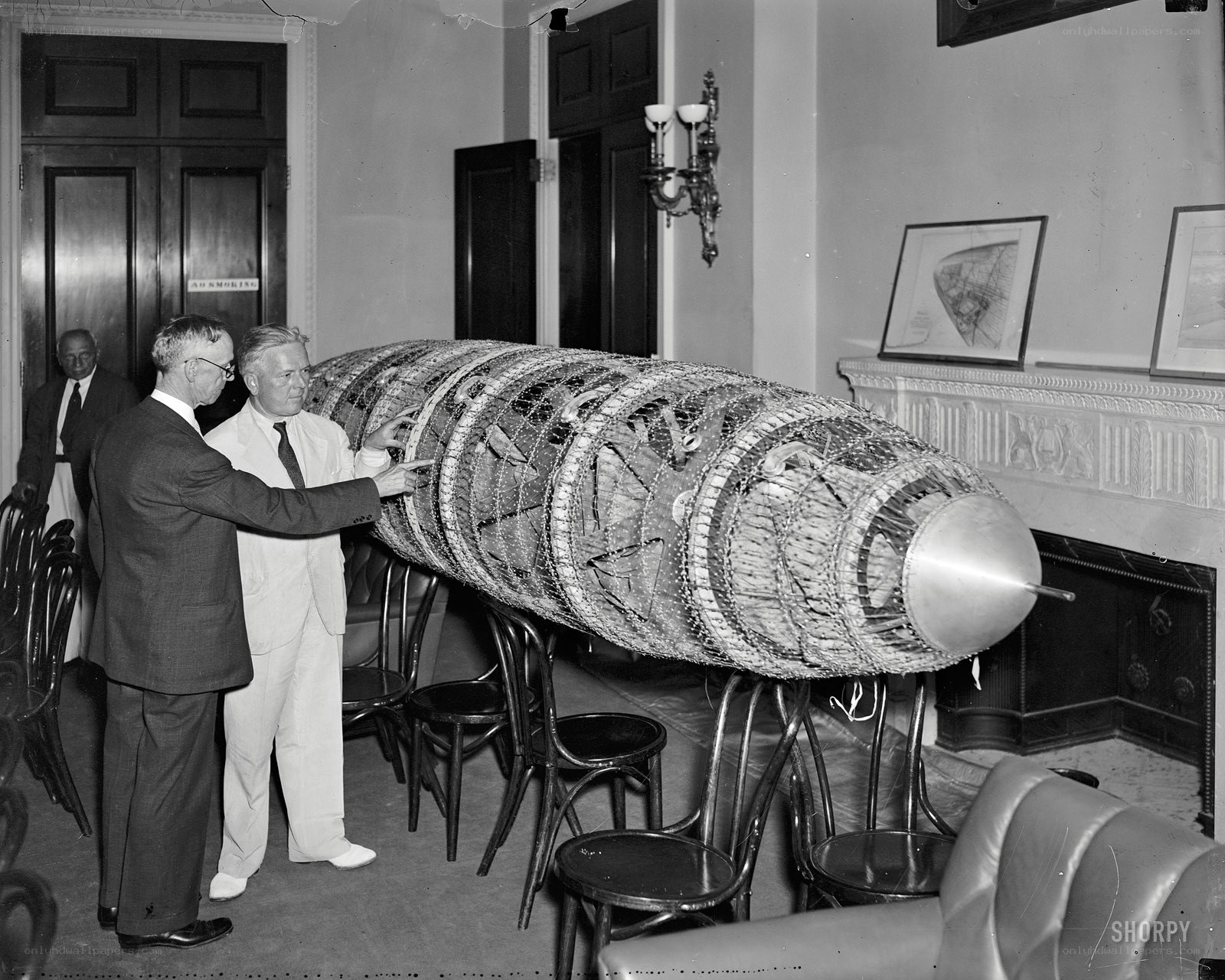 Men with bomb model in room