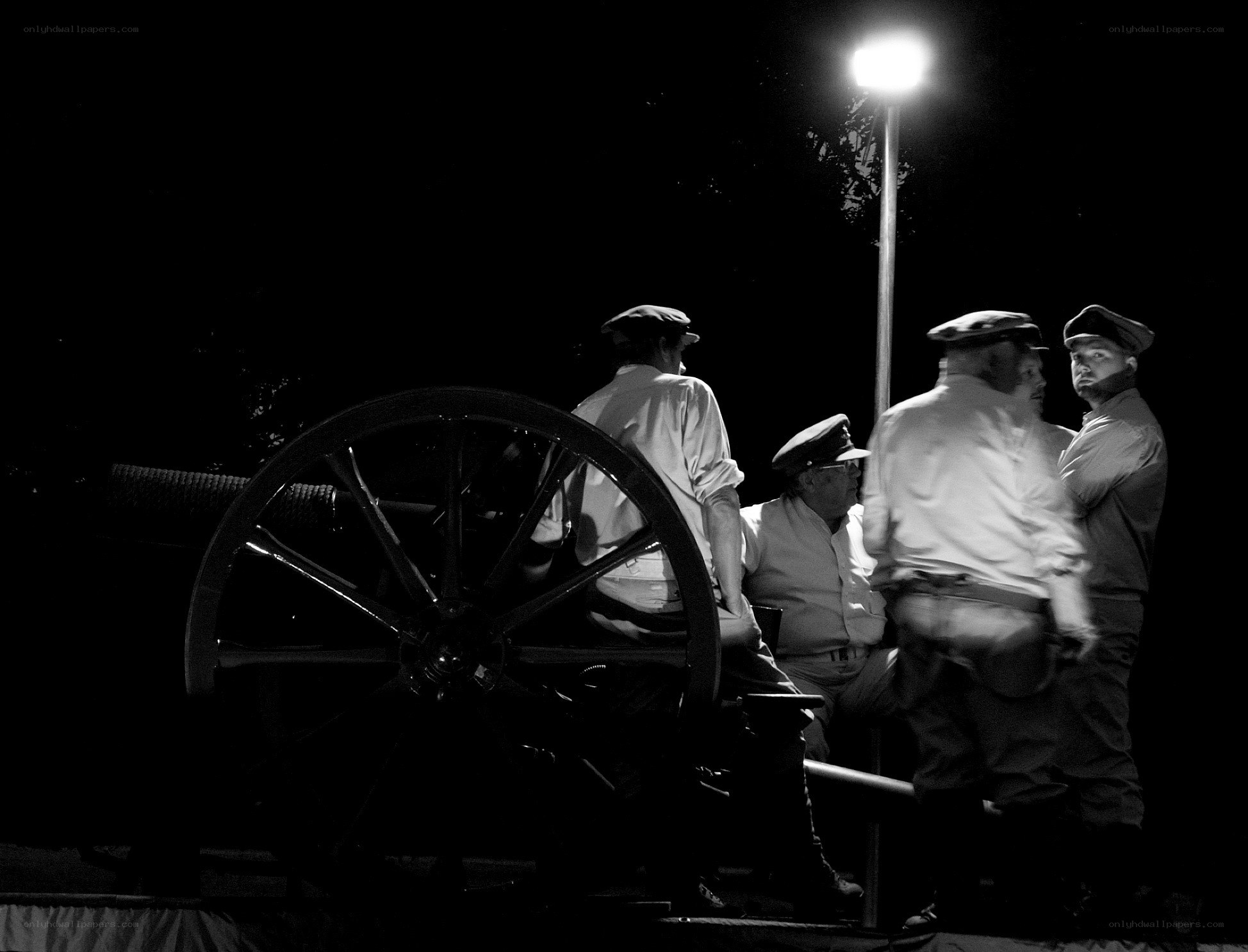 Men with cannon at night