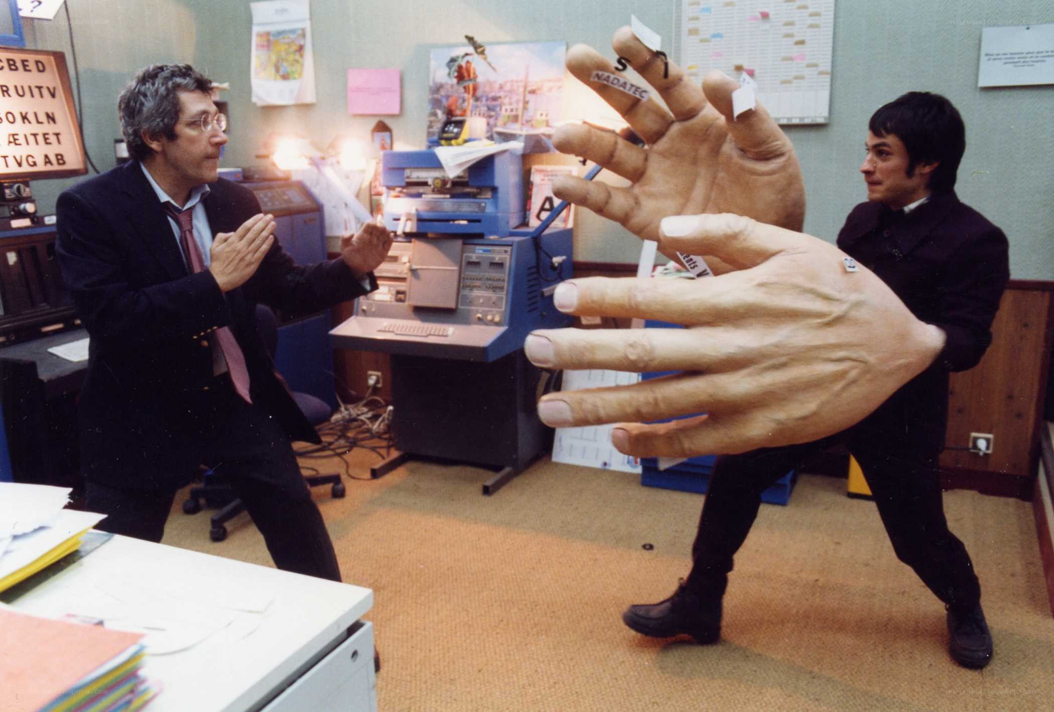 Men with giant hands in office