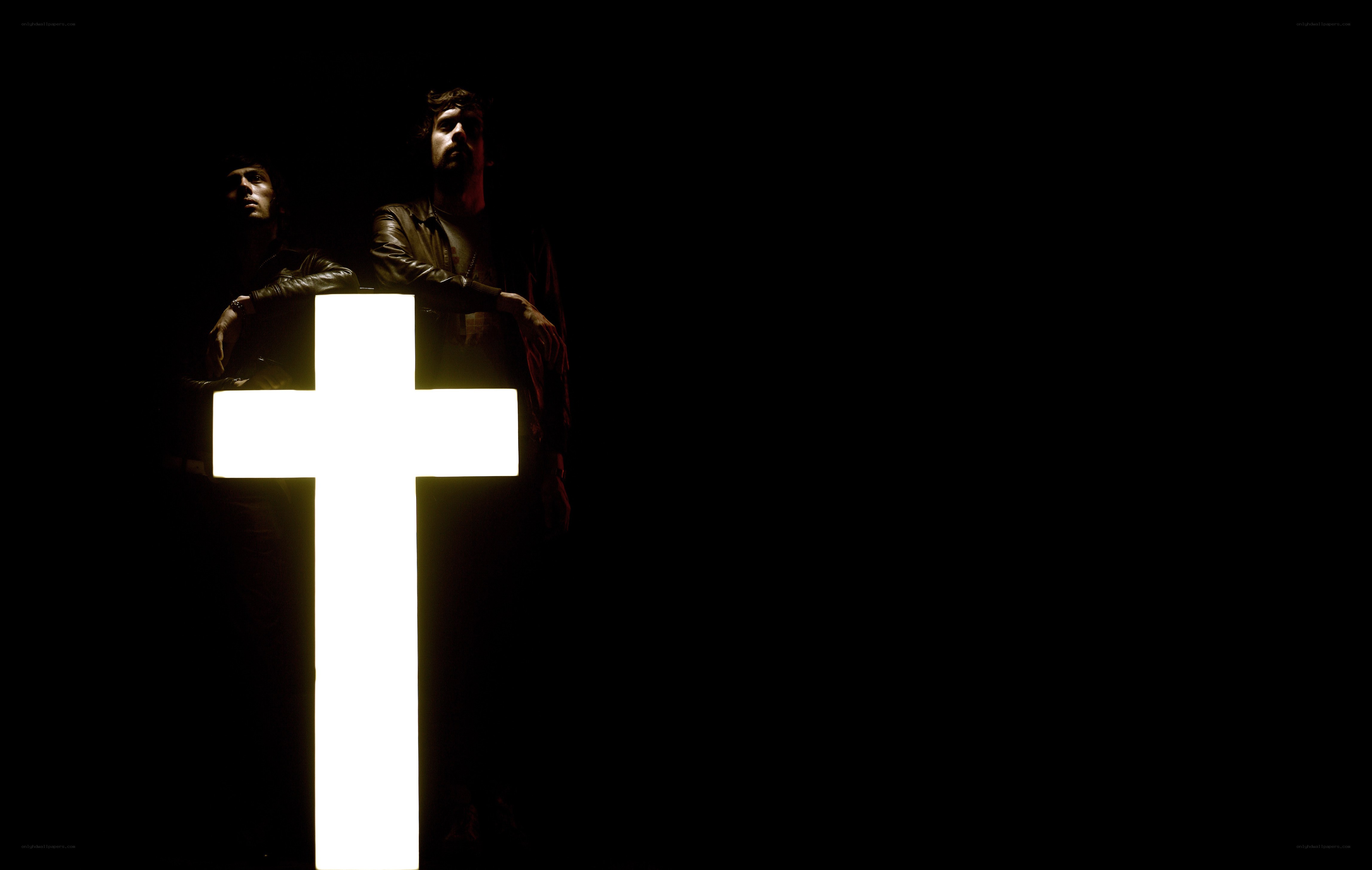 men with glowing cross