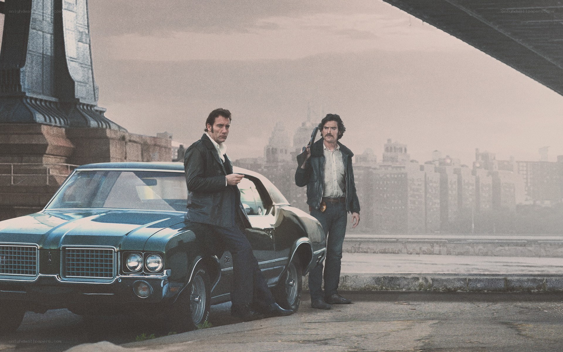 Men with guns by a car