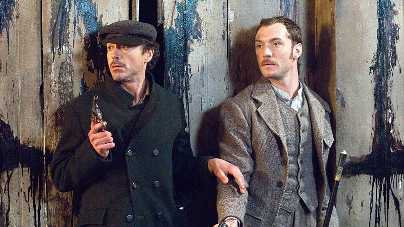 Men with guns in a dark alley