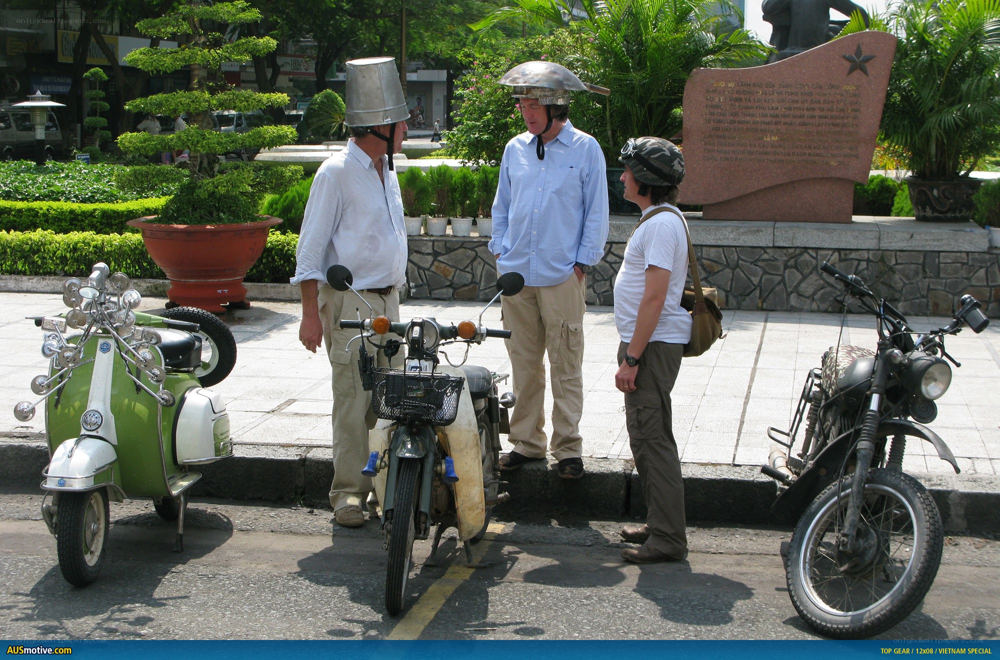 Men with helmets on scooters