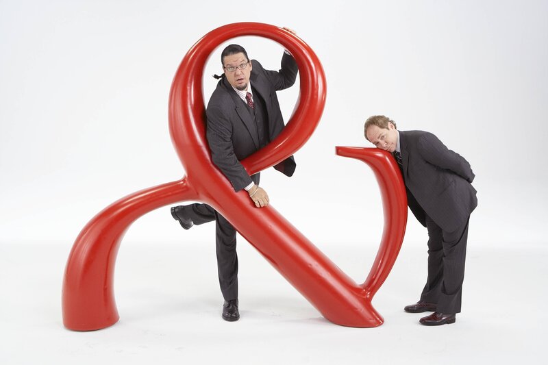Men with large ampersand sculpture