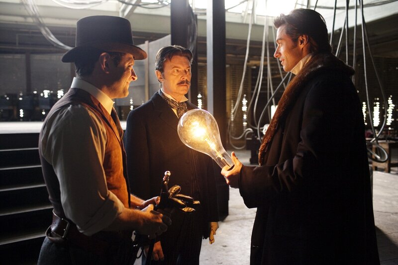 men with light bulb in lab