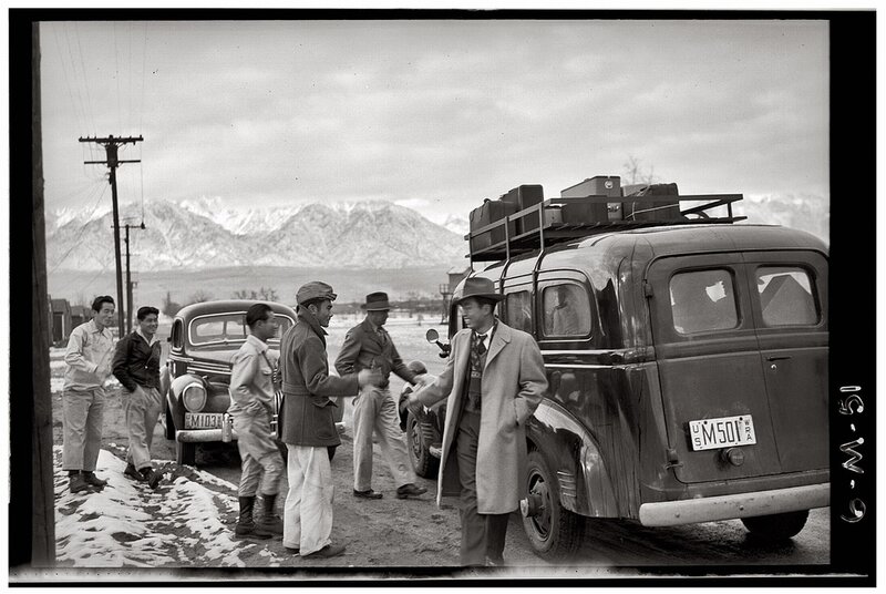 Men with luggage near vintage car