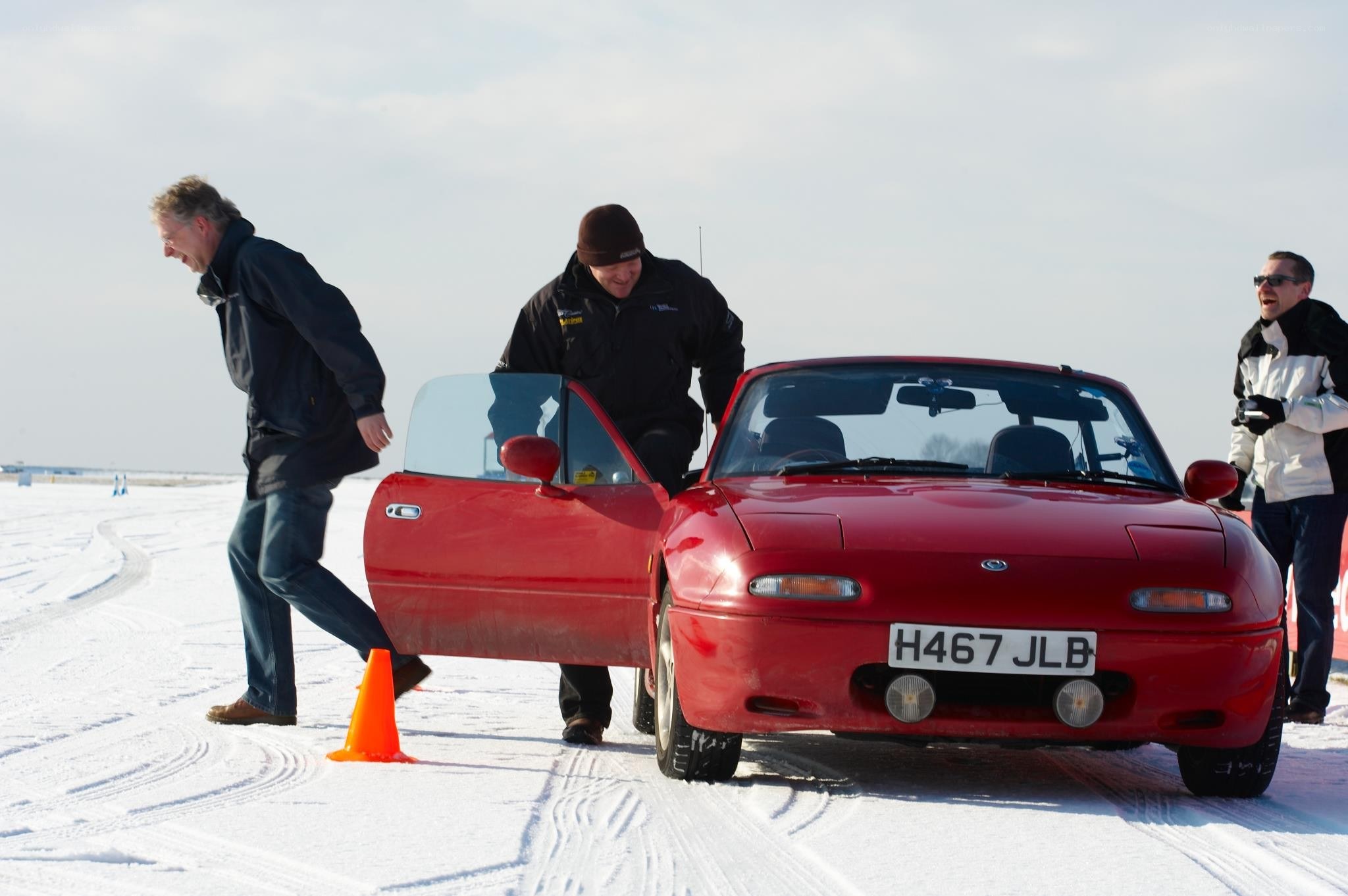 Men with red car on ice