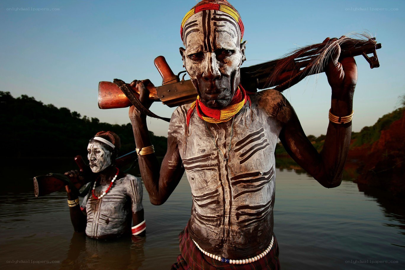 Men with rifles in water