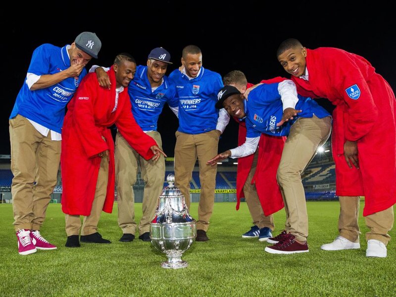 Men with Trophy on Field