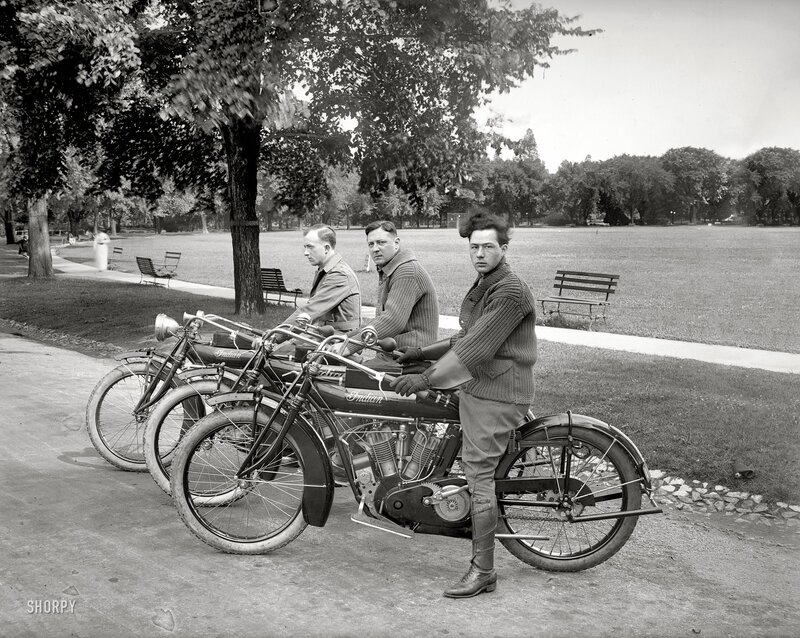 Men with vintage motorcycles in park