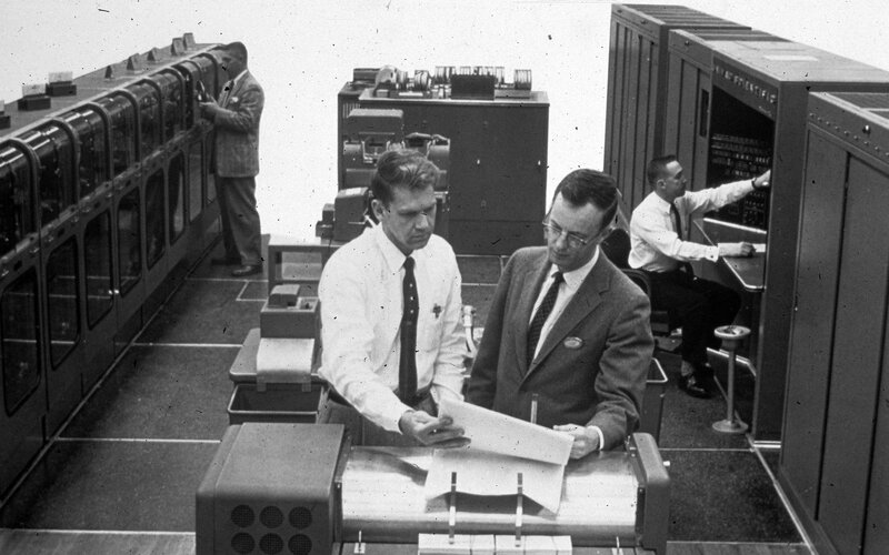 Men working in computer room