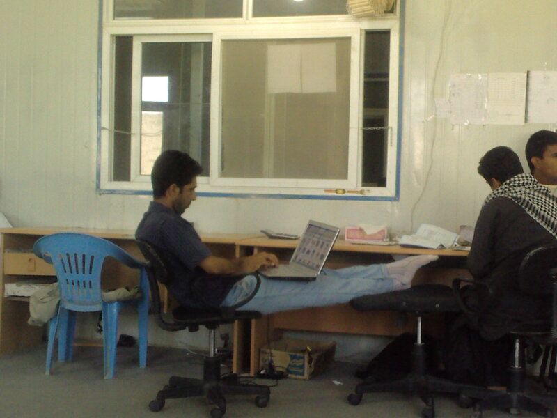 Men working on laptops in office