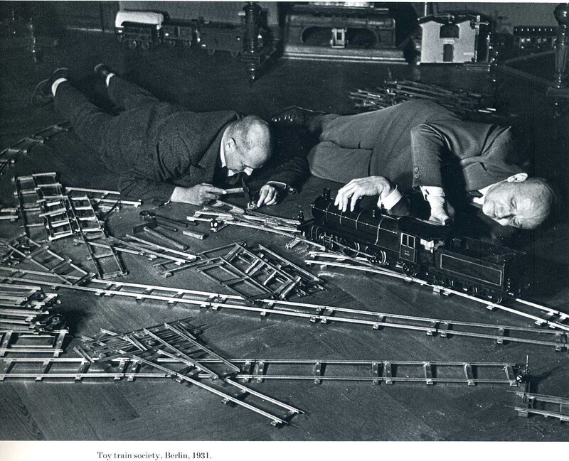 Men working on model train tracks
