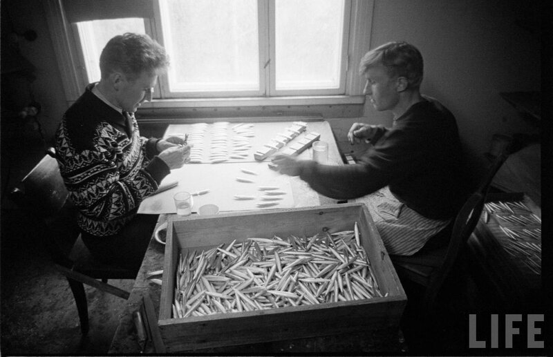Men working with fish at a table