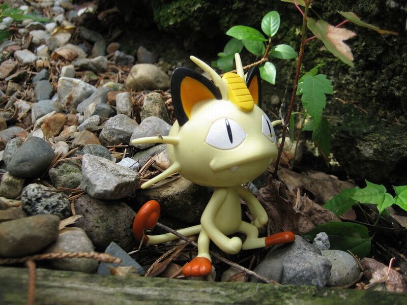 Meowth Figurine on Rocks