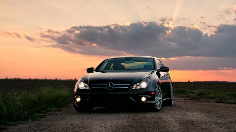 Mercedes-Benz on a dirt road at sunset