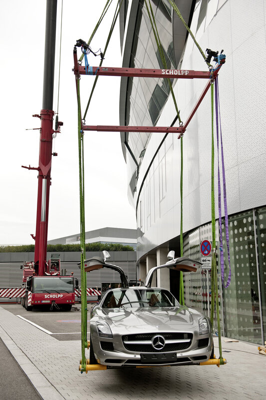 Mercedes-Benz SLS being lifted by crane