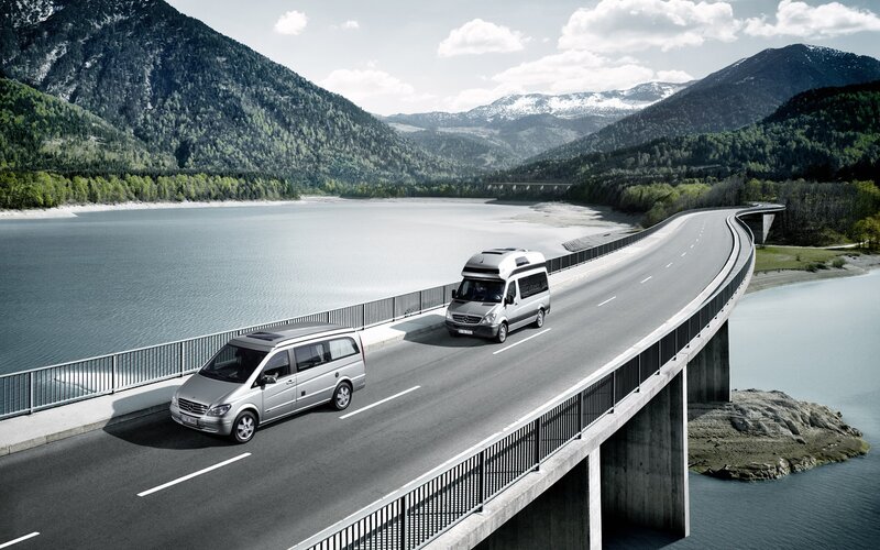 Mercedes-Benz vans on a scenic bridge